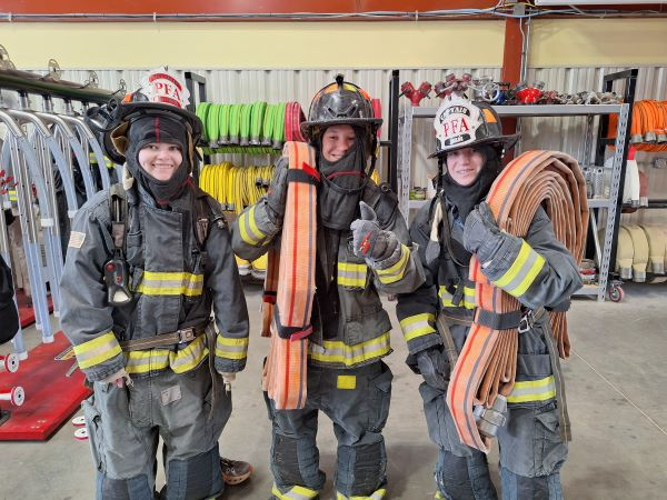 NextGenServe teens trying on fire fighting suits!